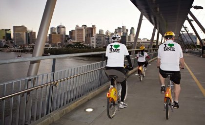 Image: Brisbane City Council Two men on bicycles riding over a bridge on the Brisbane River